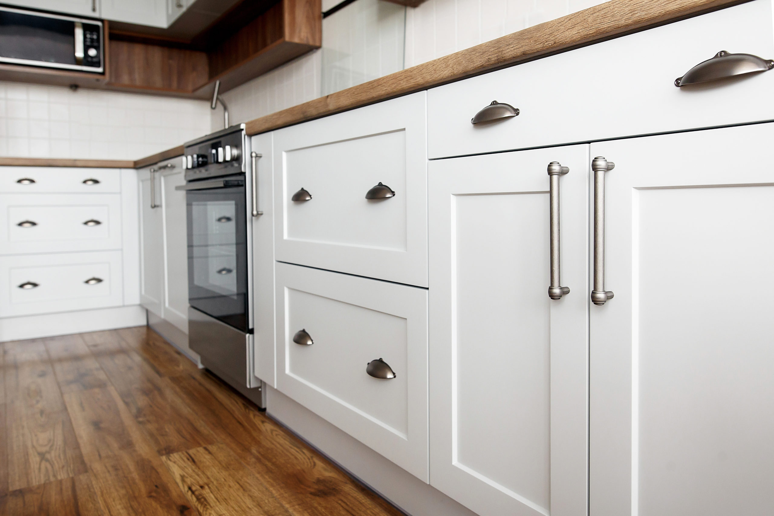 Light gray kitchen interior with modern cabinets and stainless s